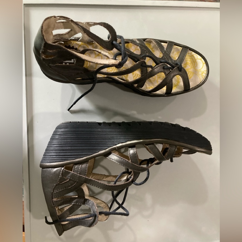 Strappy, bronze Fly London sandals.